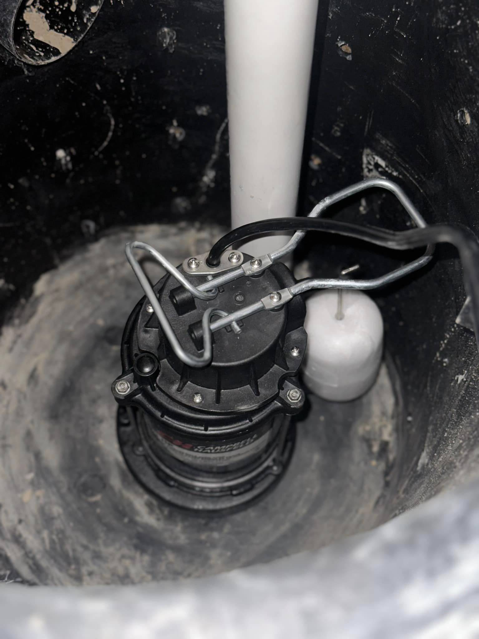 A basement sump pump installed in a home, with a discharge pipe directing water away from the foundation. Essential for flood prevention, water damage protection, and maintaining a dry basement.